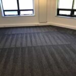 This is a photo of a grey office carpet that has just been professionally steam cleaned works carried out by Borehamwood Carpet Cleaning