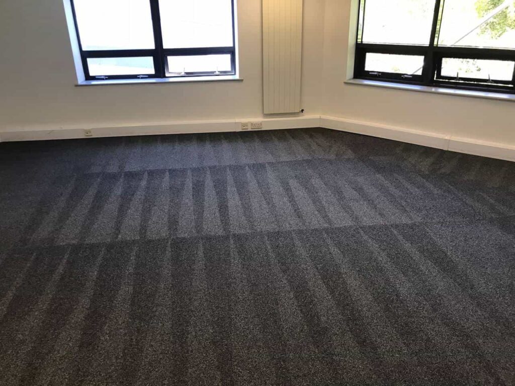 This is a photo of a grey office carpet that has just been professionally steam cleaned works carried out by Borehamwood Carpet Cleaning