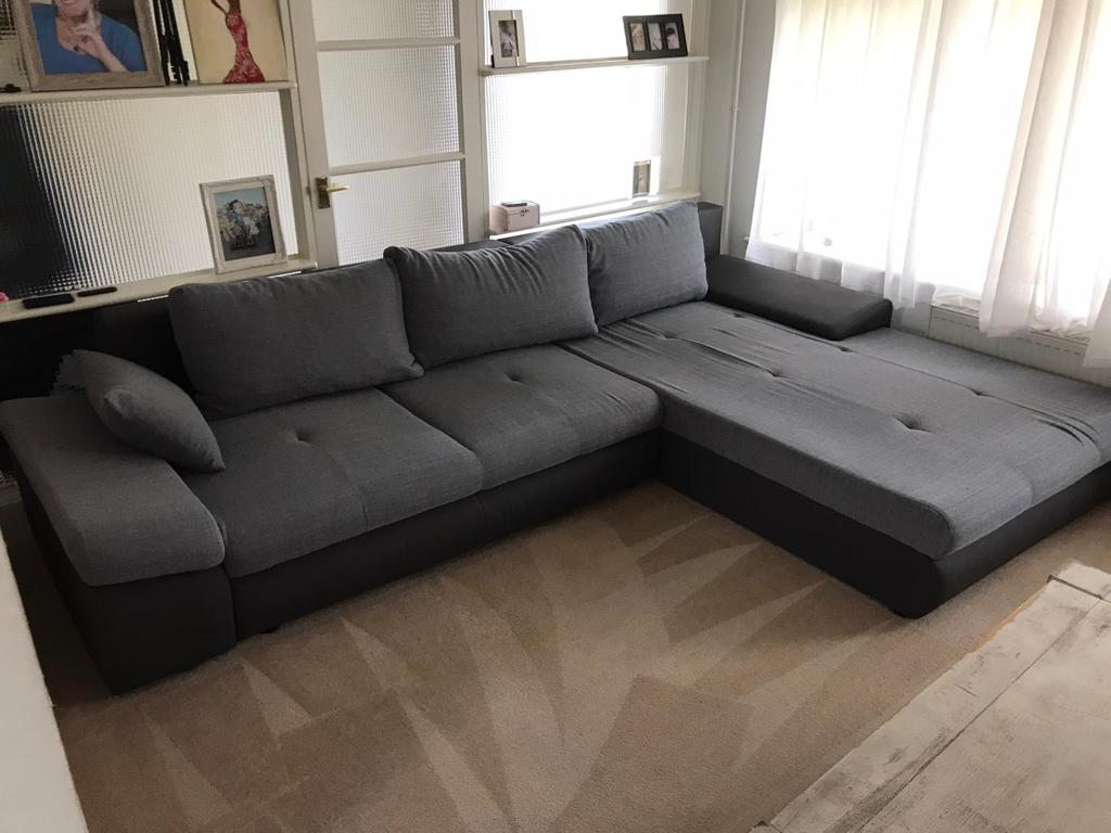 This is a photo of a grey L shape sofa that has been professionally steam cleaned, also the beige carpets have been steam cleaned too works carried out by Borehamwood Carpet Cleaning