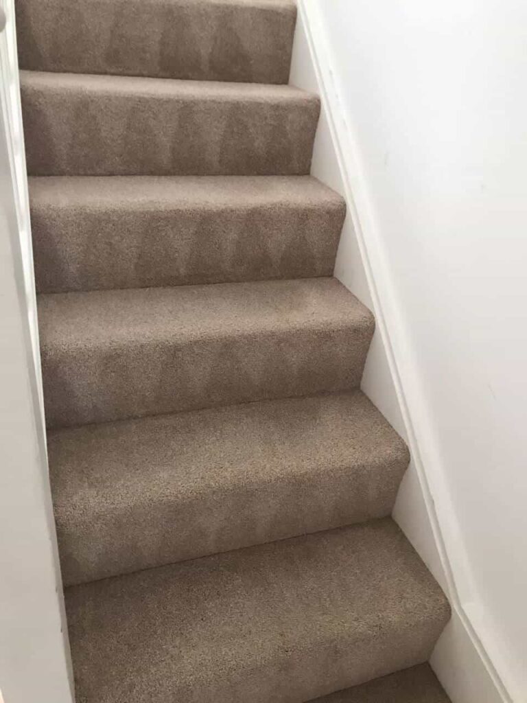 This is an after photo of a staircase with a beige carpet that has been cleaned works carried out by Borehamwood Carpet Cleaning