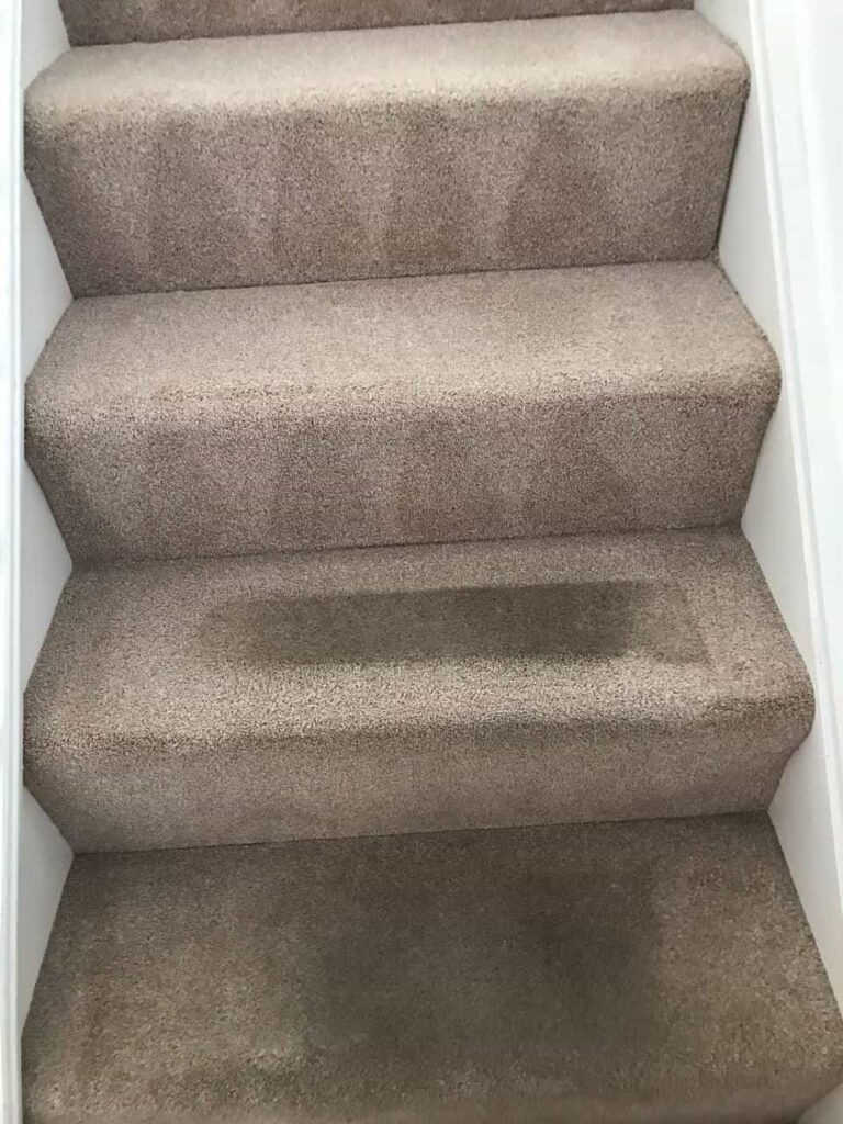 this is a photo of a staircase with beige carpets that is in the process of being cleaned works carried out by Borehamwood Carpet Cleaning